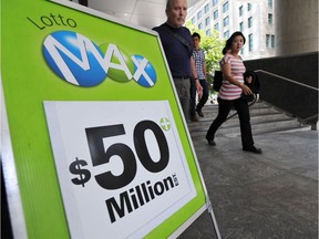 A Lotto Max sign stands on West Cordova Street in Vancouver. Four co-workers of Hung Sengsouvanh, who won the $1-million Maximillions prize in December, are suing him, claiming they contributed to the winning ticket but he refuses to share the prize.
