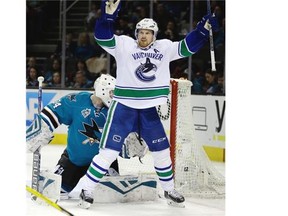 Vancouver Canucks’ Daniel Sedin, right, celebrates after scoring a goal against San Jose Sharks goalie James Reimer (34) during the second period of an NHL hockey game Saturday, March 5, 2016, in San Jose, Calif.