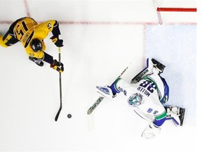 Vancouver Canucks goalie Ryan Miller (30) blocks a shot by Nashville Predators center Craig Smith (15) during the first period of an NHL hockey game Thursday, March 24, 2016, in Nashville, Tenn. (AP Photo/Mark Humphrey)