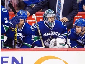 Vancouver Canucks’ goalie Ryan Miller sits on the bench with teammates Alexandre Grenier, left, and Dan Hamhuis during third period of their 3-0 loss to the St. Louis Blues at Rogers Arena on Saturday. Miller was one of the few bright lights for the Canucks, making 47 saves in the loss.