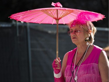 A fan uses an umbrella for sun protection at the main stage at the 39th annual Folk Music Festival at Jericho Beach, Vancouver, July 16 2016.