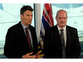 Vancouver Mayor Gregor Robertson and BC Finance Minister Mike de Jong discuss a proposal for a city vacancy tax on June 27, 2016. [PNG Merlin Archive]