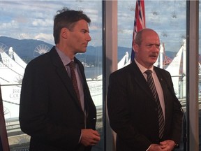Vancouver mayor Gregor Robertson (left) and B.C. finance minister Mike de Jong speak to the media on June 27, 2016 following a meeting to discuss a city proposal to impose a vacancy tax.