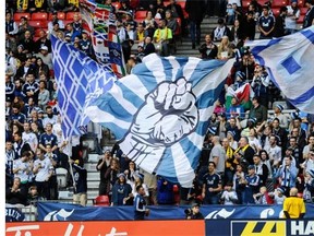 Vancouver Whitecaps fans welcome their team at the start of their game against the Houston Dynamo in BC Place Stadium last October.