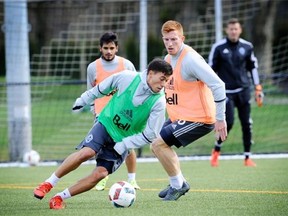Vancouver Whitecaps midfielder Nicolas Mezquida pivots away from defending centre back Tim Parker during a Vancouver Whitecaps training session at UBC on Wednesday, March 2, 2016. The Whitecaps host the Montreal Impact in the MLS regular season opener for both teams on Sunday.
