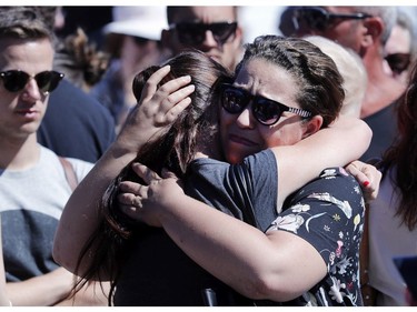 Women react near the scene where a truck mowed through revelers in Nice, southern France, Friday, July 15, 2016.  A Tunisian living in France drove a large truck through crowds celebrating Bastille Day along Nice's beachfront, killing more than 80 people, many of them children, according to police and hospital officials.