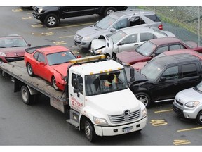 Workers at the ICBC damaged vehicle lot at the south end of the Queensborough Bridge in Richmond. A judge has ordered ICBC to pay an immigrant couple more than $350,000 after the corporation falsely accused them of insurance fraud. In a judgment issued Tuesday, Justice Susan Griffin called the prosecution brought against Danica Arsenovski “malicious,” and said that the actions by ICBC and special investigator John Gould “brought fear and shame to a vulnerable person.”