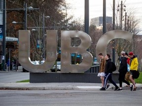 FILE: Young men walk past large letters spelling out UBC at the University of British Columbia in Vancouver, B.C., on November 22, 2015.