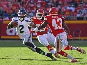 Quarterback Trevone Boykin #2 of the Seattle Seahawks rushes up field against safety Akeem Davis #43 of the Kansas City Chiefs.