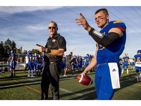 UBC head coach Blake Nill and starting quarterback Michael O'Connor share a moment on the sidelines before Friday's one-sided loss to the Manitoba Bisons. (Bob Frid/UBC athletics) [PNG Merlin Archive]