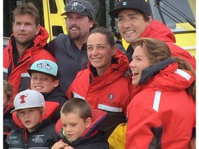 Prime Minister Justin Trudeau, his wife, Sophie Grégoire Trudeau, right, and their family pose with whale-watching staff as they took in activities around Tofino during a vacation stop this week.
