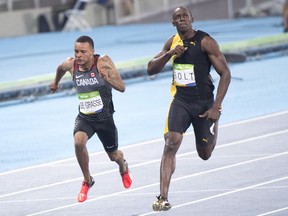 Usain Bolt has been stripped of one of his nine Olympic gold medals in a doping case involving teammate Nesta Carter. Jamaica's Usain Bolt, right, celebrates as he wins the men's 100-metre final ahead of third place finisher Canada's Andre De Grasse during the athletics competition at the 2016 Summer Olympics in Rio de Janeiro, Brazil, Sunday, August 14, 2016.
