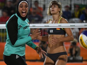 Germany's Laura Ludwig watches as Egypt's Doaa Elghobashy reacts during the women's beach volleyball qualifying match between Germany and Egypt.