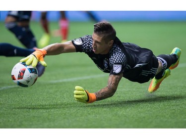 San Jose Earthquakes' goalkeeper David Bingham dives to make a save against the Vancouver Whitecaps during the first half of an MLS soccer game in Vancouver, B.C., on Friday August 12, 2016.