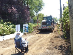 Diana Davidson sits in protest of an effort to pave the Arbutus Greenway on Thursday. Courtesy Mark Battersby.