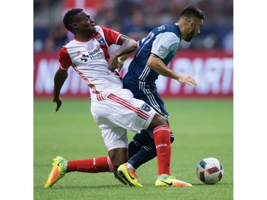 San Jose Earthquakes' Fatai Alashe, left, and Vancouver Whitecaps' Pedro Morales vie for the ball during the first half of an MLS soccer game in Vancouver, B.C., on Friday August 12, 2016.