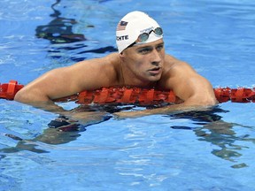 FILE - In this Aug. 9, 2016, file photo, United States' Ryan Lochte checks his time after a men' 4x200-meter freestyle relay heat during the swimming competitions at the 2016 Summer Olympics in Rio de Janeiro, Brazil.