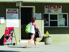 A woman walks past the office at South Beach Gardens Campground on Monday while the business was in the midst of a social media firestorm.