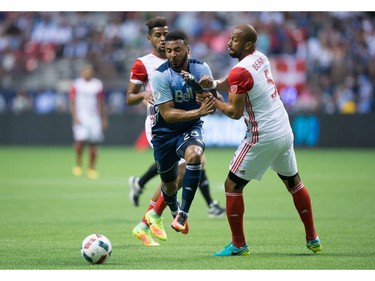 Vancouver Whitecaps' Giles Barnes, left, collides with San Jose Earthquakes' Victor Bernardez as he moves the ball past him during the first half of an MLS soccer game in Vancouver, B.C., on Friday August 12, 2016.