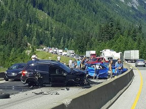 Wrecked vehicles block the Coquihalla Highway's southbound lanes east of Hope after a Friday afternoon crash.