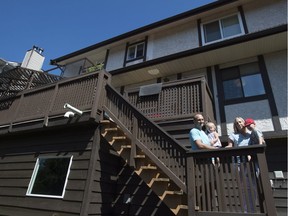 Heather Nyberg along with husband Dan Zimmermann and son Leo and daughter Isabel pose for a photo outside their home in Coquitlam, B.C., Friday, August, 5, 2016. The family say they are affected by the B.C. government's new tax on foreign buyers making the sale of their home fall though.