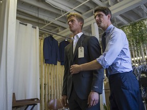 Tailor Michael Mahood, Martin Fisher Tailors, makes adjustments to a suit worn by field hockey player Floris van Son at his tailor shop in Vancouver.