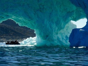 Icebergs calved from the massive Sermeq Kujalleq or Jakobshavn Glacier glow blue in the brilliant summer sunshine. The glacier is a UNESCO World Heritage Site and the ice here has been studied for more than a century.