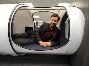 James Rout, director of library services at BCIT, gets comfortable in a sleep pod being tested out in the school's library.
