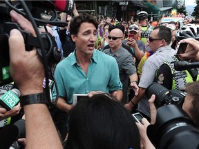 VANCOUVER, BC., July 31, 2016 -- Prime Minister Justin Trudeau talks to media at the 2016 Pride Parade in Vancouver, BC., July 31, 2016. With him are his wife, Sophie Gregoire Trudeau and Children Xavier, 8, Ella-Grace, 6, and Hadrien.  (Nick Procaylo/PNG)   00044441A [PNG Merlin Archive]