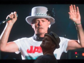 A Tragically Hip fan stands in front of the big screen at a live viewing party in Vancouver for the band’s final show. Singer Gord Downie was diagnosed with terminal brain cancer earlier this year.