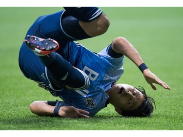 Vancouver Whitecaps' Masato Kudo, of Japan, tumbles to the ground after an unsuccessful shot on goal against the San Jose Earthquakes during the first half of an MLS soccer game in Vancouver, B.C., on Friday August 12, 2016.