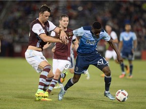 Vancouver Whitecaps midfielder Alphonso Davies battles with Colorado Rapids defender Bobby Burling for control of the ball in the second half of the match at Dick's Sporting Goods Park. The Rapids defeated the Whitecaps 2-0.