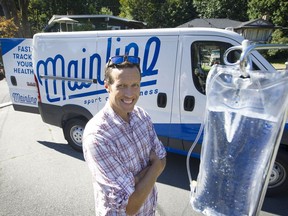 Dr. Adam Davidson in front of the van used by his  mobile IV service, Mainline Sport and Wellness.