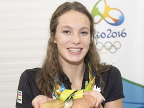 Canada's athletes will see a raise in their monthly cheque. Canada's Penny Oleksiak, from Toronto, holds up her four medals, a gold, silver and two bronze, she won at the 2016 Summer Olympics during a news conference Sunday, August 14, 2016 in Rio de Janeiro, Brazil. Oleksiak will carry the Canadian flag into Maracana Stadium for tonight's Olympic closing ceremony.THE CANADIAN PRESS/Ryan Remiorz ORG XMIT: RYR102