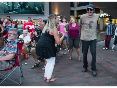 A woman and man dance during a viewing party for the final stop in Kingston, Ont., of a 10-city national concert tour by The Tragically Hip, in Vancouver, B.C., on Saturday August 20, 2016. Lead singer Gord Downie announced earlier this year that he was diagnosed with an incurable form of brain cancer.