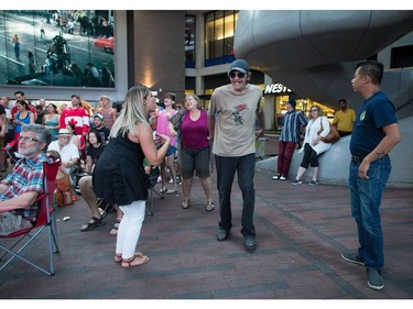 A woman and man dance during a viewing party for the final stop in Kingston, Ont., of a 10-city national concert tour by The Tragically Hip, in Vancouver, B.C., on Saturday August 20, 2016. Lead singer Gord Downie announced earlier this year that he was diagnosed with an incurable form of brain cancer.