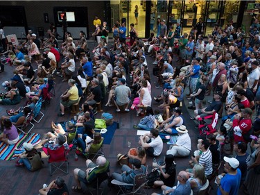 People gather during a viewing party for the final stop in Kingston, Ont., of a 10-city national concert tour by The Tragically Hip, in Vancouver, B.C., on Saturday August 20, 2016. Lead singer Gord Downie announced earlier this year that he was diagnosed with an incurable form of brain cancer.