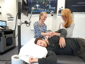 Physiotherapist Robyn Roots helps first year physio student Saja Edwards, while fellow student Ryan Petterson acts as the patient.