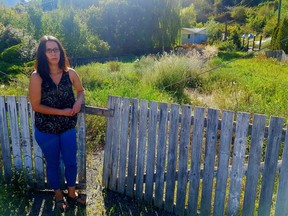 Lacey LaRochelle stands in front of her Lillooet home, which has been uninhabitable since a series of landslides in 2011.