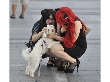 Amanda (left) and Rose (right) say hi to Totto the dog as people dress up in character for the Anime Revolution at Vancouver Convention Centre in Vancouver, BC. August 5, 2016. Anime Revolution is the largest three-day Anime convention located in Vancouver, Canada.