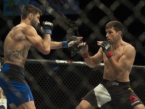 Carlos Condit (in blue) versus Demian Maia (in black and white) in the main card welterweight bout.