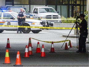 Police investigate a homicide at Shaughnessy Square at the corner of Flint Street and Coquitlam Avenue in Port Coquitlam on Sunday.