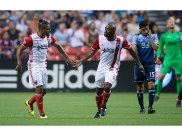 San Jose Earthquakes' Quincy Amarikwa, left, and Marvell Wynne celebrate Amarikwa's goal as Vancouver Whitecaps' Matias Laba, far right, looks on during the first half of an MLS soccer game in Vancouver, B.C., on Friday August 12, 2016.