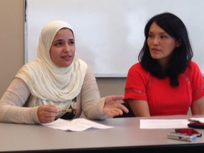 Rasha Moursy (left), a settlement worker with the Pacific Immigrant Resources Society, talks about some of the situations she's encountered working with refugee women as NDP MLA Jenny Kwan looks on.