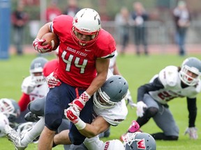 Simon Fraser running back Ante Litre powers his way through a pack of Western Oregon Wolves during GNAC play last season at Swangard Stadium. Litre and the Clan, coming off a winless 2015, open play Saturday on the road against Idaho State. (Ron Hole/SFU athletics) [PNG Merlin Archive]