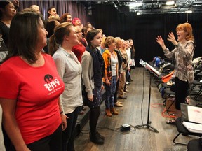 Sing City choir members learn how to 'open wide' under the instruction of Laura Lang.