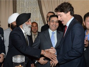 Prime Minister Justin Trudeau warmly greets long-time Liberal organizer Prem Vinning (left) at a Liberal fundraiser event in Surrey last March.