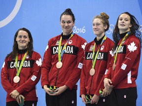 The Canadian women's 4x100-metre freestyle relay team, left to right, Sandrine Mainville, Chantal van Landeghem, Taylor Ruck and Penny Oleksiak receive their bronze medal at the 2016 Summer Olympics, in Rio de Janeiro, Brazil, Saturday, Aug. 6, 2016.
