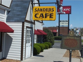 The original Sanders Cafe sign, dwarfed by a newer KFC sign and bucket, that tower over the Corbin, Ky., restaurant.