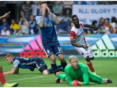 Vancouver Whitecaps' Tim Parker, back left, David Edgar and goalkeeper David Ousted, bottom right, react as San Jose Earthquakes' Simon Dawkins, back right, watches his shot enter the net for a goal during the second half of an MLS soccer game in Vancouver, B.C., on Friday August 12, 2016.